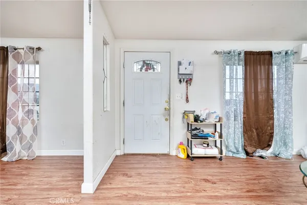 a view of a livingroom with wooden floor and a potted plant