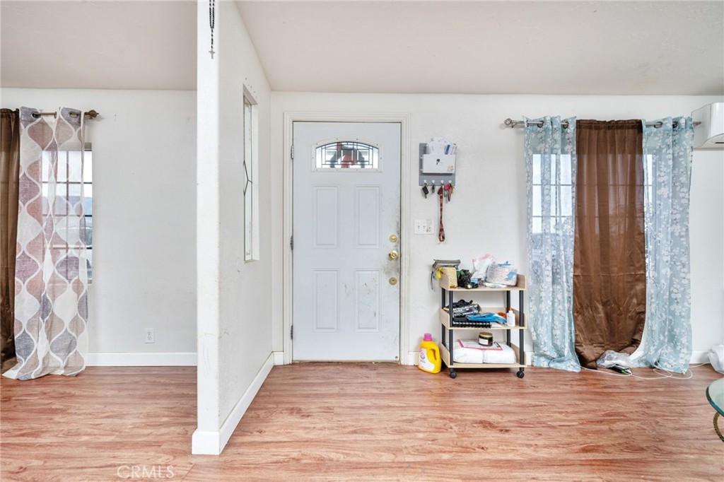 13221 Arena Road Pinon Hills, CA 92372 - Photo 2 of 19 a view of a livingroom with wooden floor and a potted plant