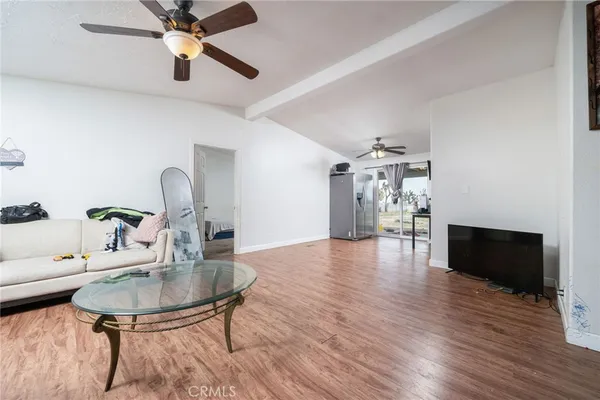 a dining room with furniture a chandelier and wooden floor