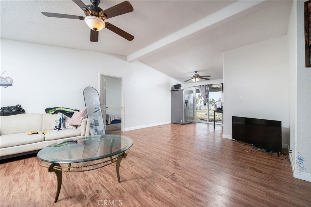 13221 Arena Road Pinon Hills, CA 92372 - Photo 3 of 19 a dining room with furniture a chandelier and wooden floor