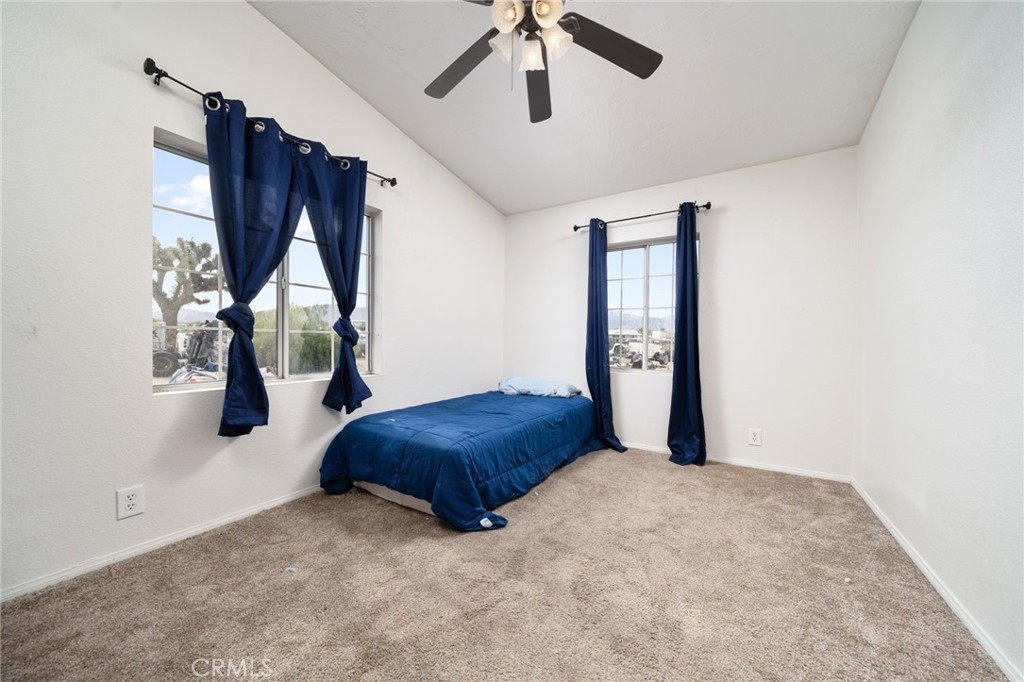 13221 Arena Road Pinon Hills, CA 92372 - Photo 10 of 19 a bedroom with a bed and a window