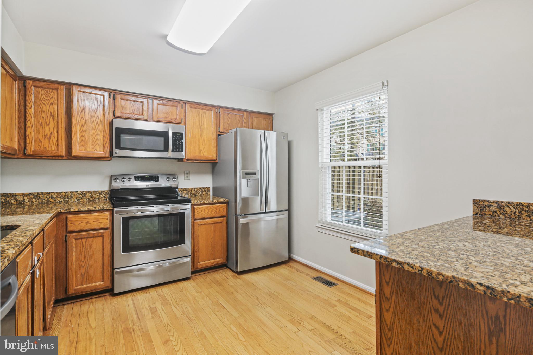 4723 Hallowed Streme Ellicott City, MD 21042 - Photo 8 of 40 Modern kitchen with warm wood accents.