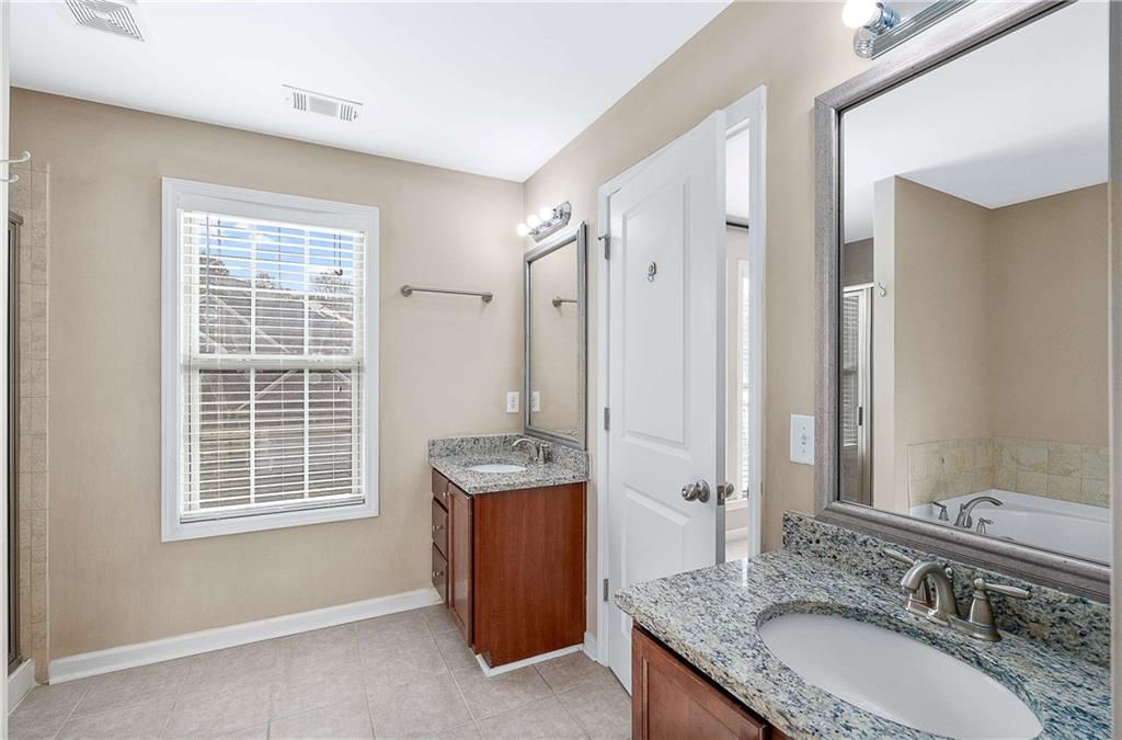3546 Flycatcher Way Duluth, GA 30097 - Photo 15 of 30 a bathroom with a granite countertop sink and a mirror