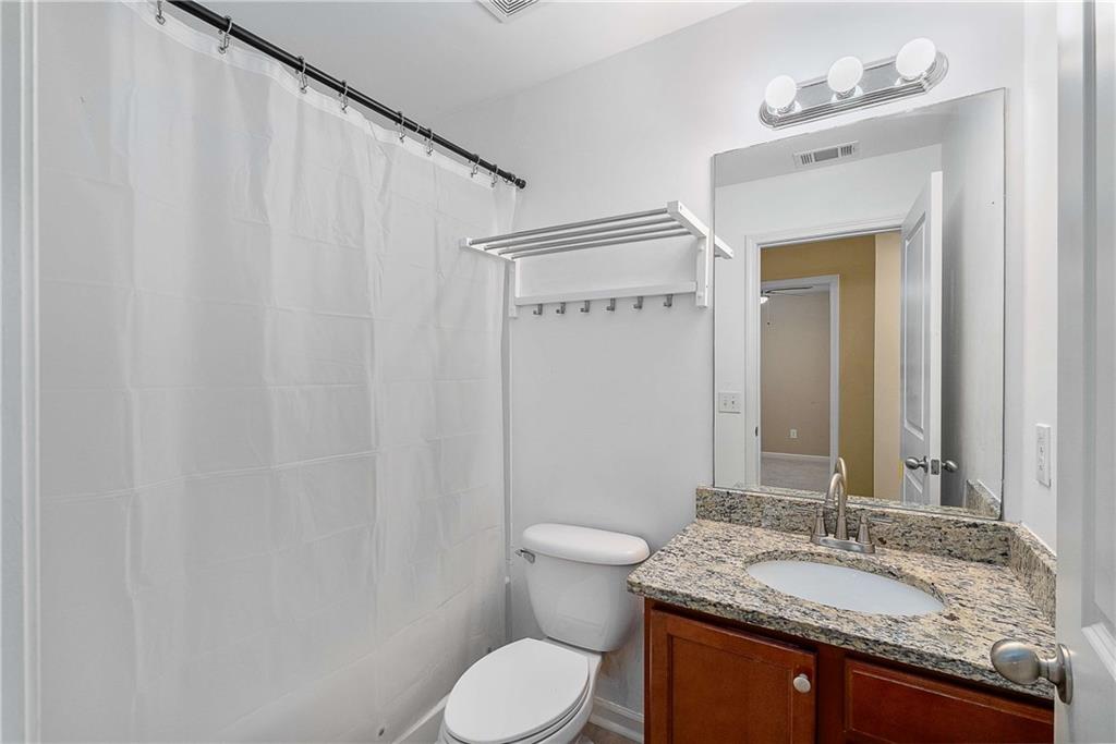3546 Flycatcher Way Duluth, GA 30097 - Photo 17 of 30 a bathroom with a granite countertop sink toilet and mirror