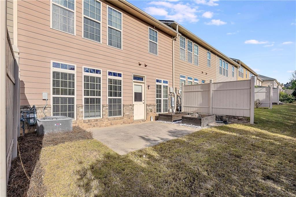 3546 Flycatcher Way Duluth, GA 30097 - Photo 25 of 30 a view of a house with a patio and a yard