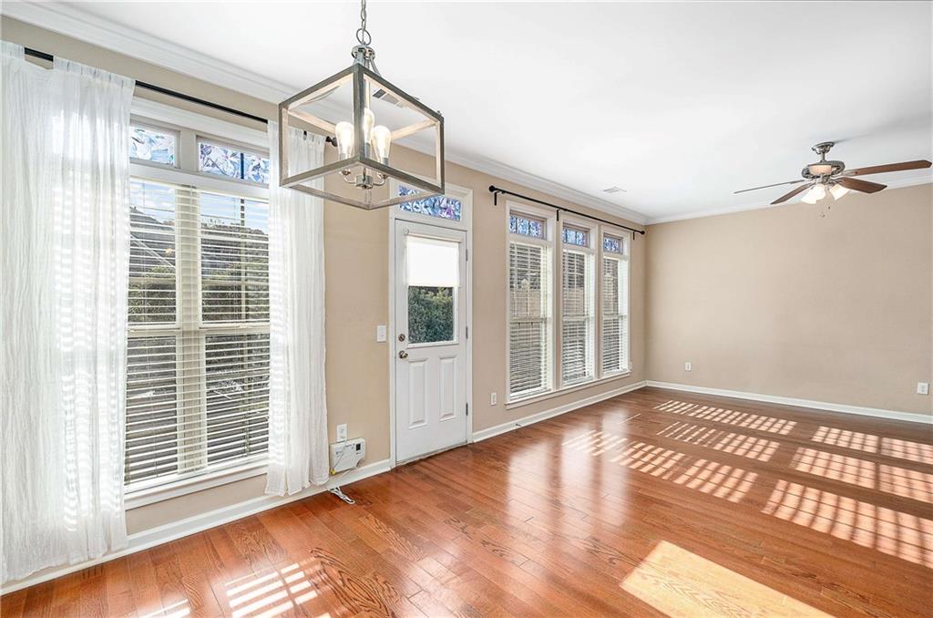 3546 Flycatcher Way Duluth, GA 30097 - Photo 10 of 30 a view of an empty room with wooden floor and a window