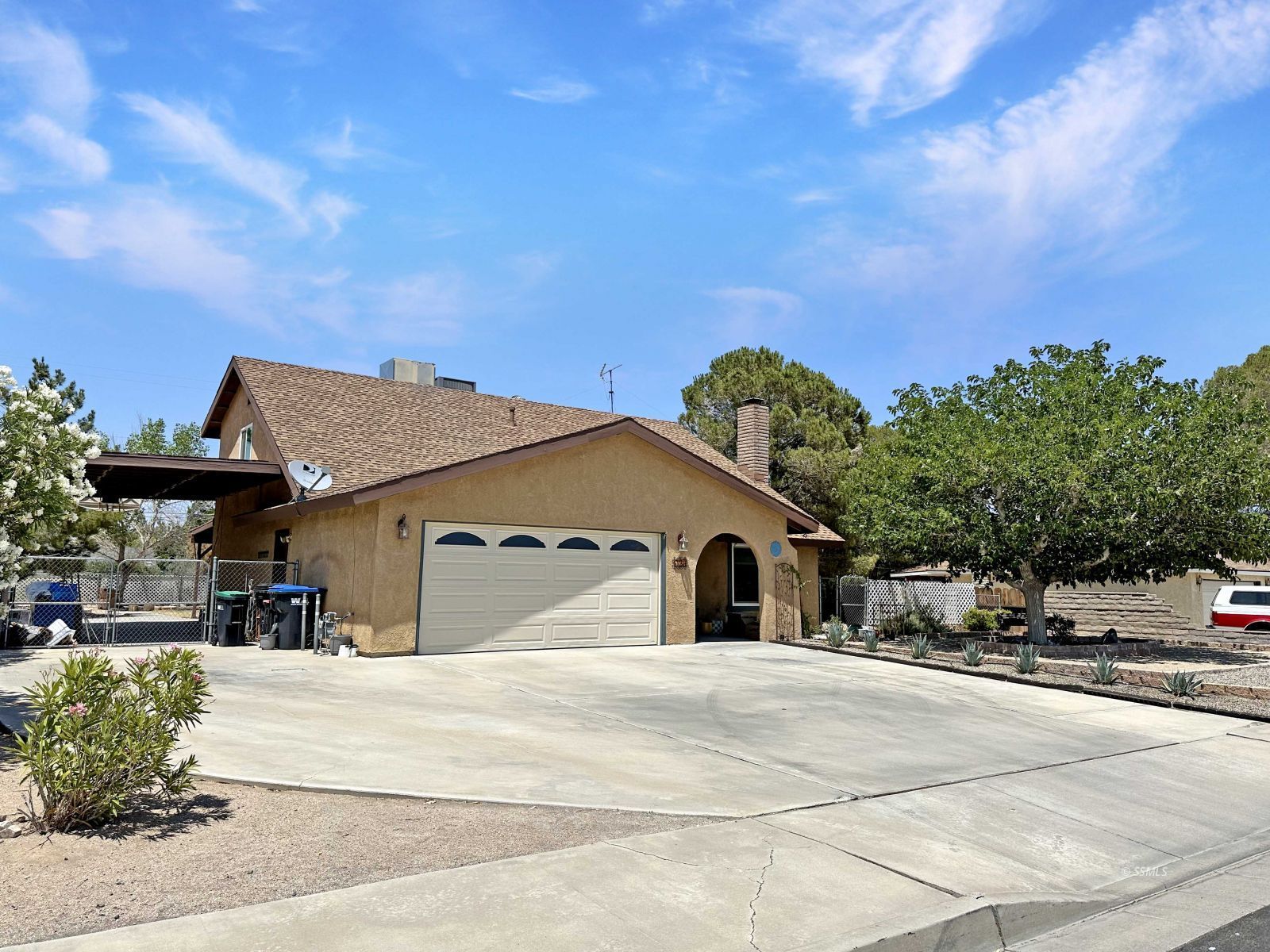 724 West Dolphin Avenue Ridgecrest, CA 93555 - Photo 3 of 50 a view of a white house with a yard