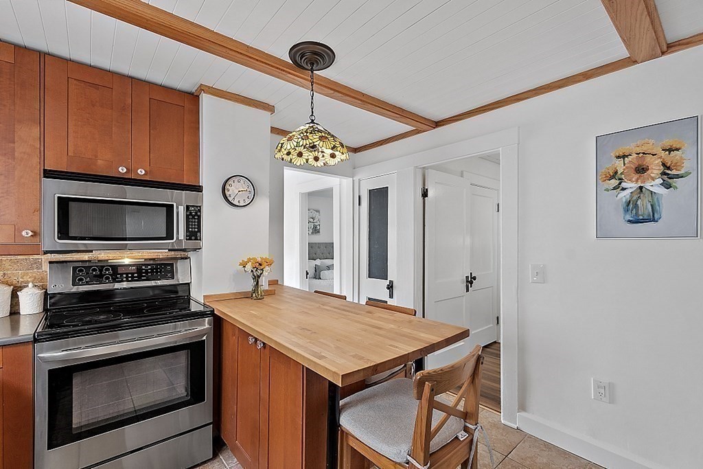 26 Madison Square Gloucester, MA 01930 - Photo 12 of 27 a kitchen with a stove and a microwave