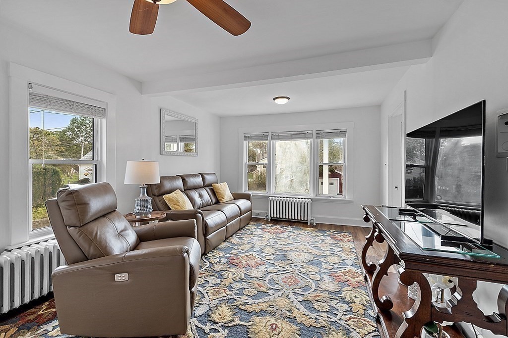 26 Madison Square Gloucester, MA 01930 - Photo 6 of 27 a living room with furniture a window and a flat screen tv