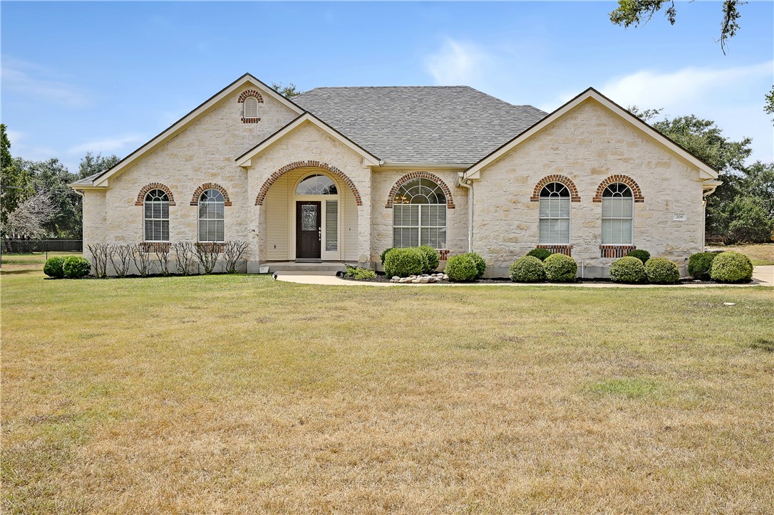 a front view of house with yard and green space