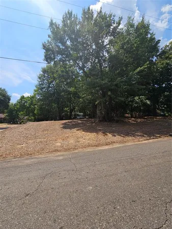 a view of a field with trees in background