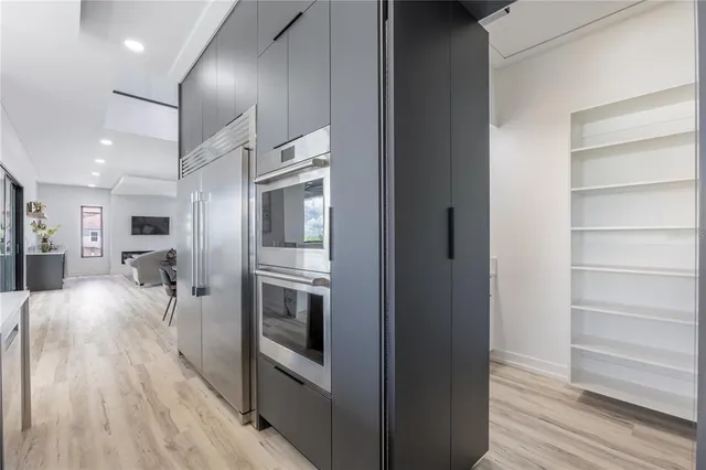 a living room with a couch and chandelier