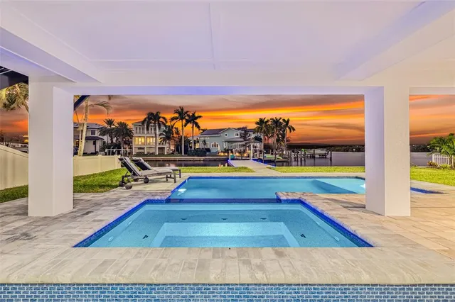 a large kitchen with stainless steel appliances granite countertop a lot of counter space and wooden floors