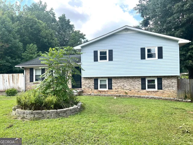 a front view of a house with garden