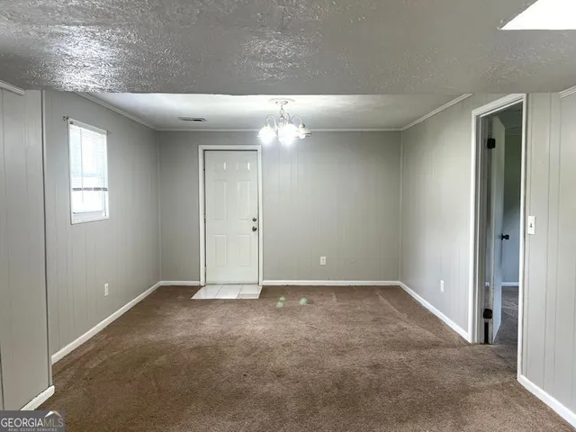 en empty room with windows and ceiling fan