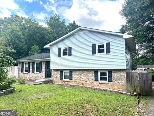 a front view of a house with a garden