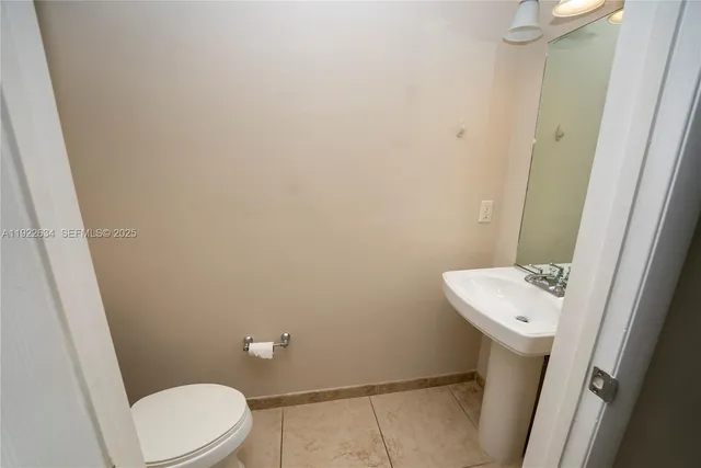 a white toilet sitting next to a white sink