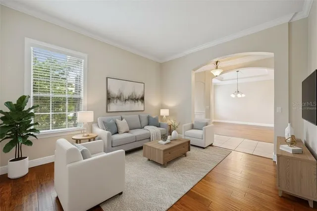 a view of a dining room with furniture wooden floor and chandelier