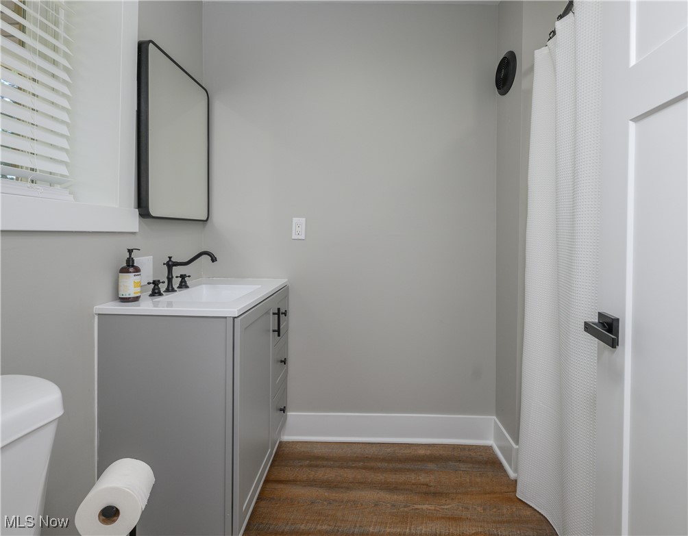 3029 Werner Church Road Northeast Canton, OH 44721 - Photo 16 of 33 Bathroom featuring hardwood / wood-style floors, toilet, and vanity
