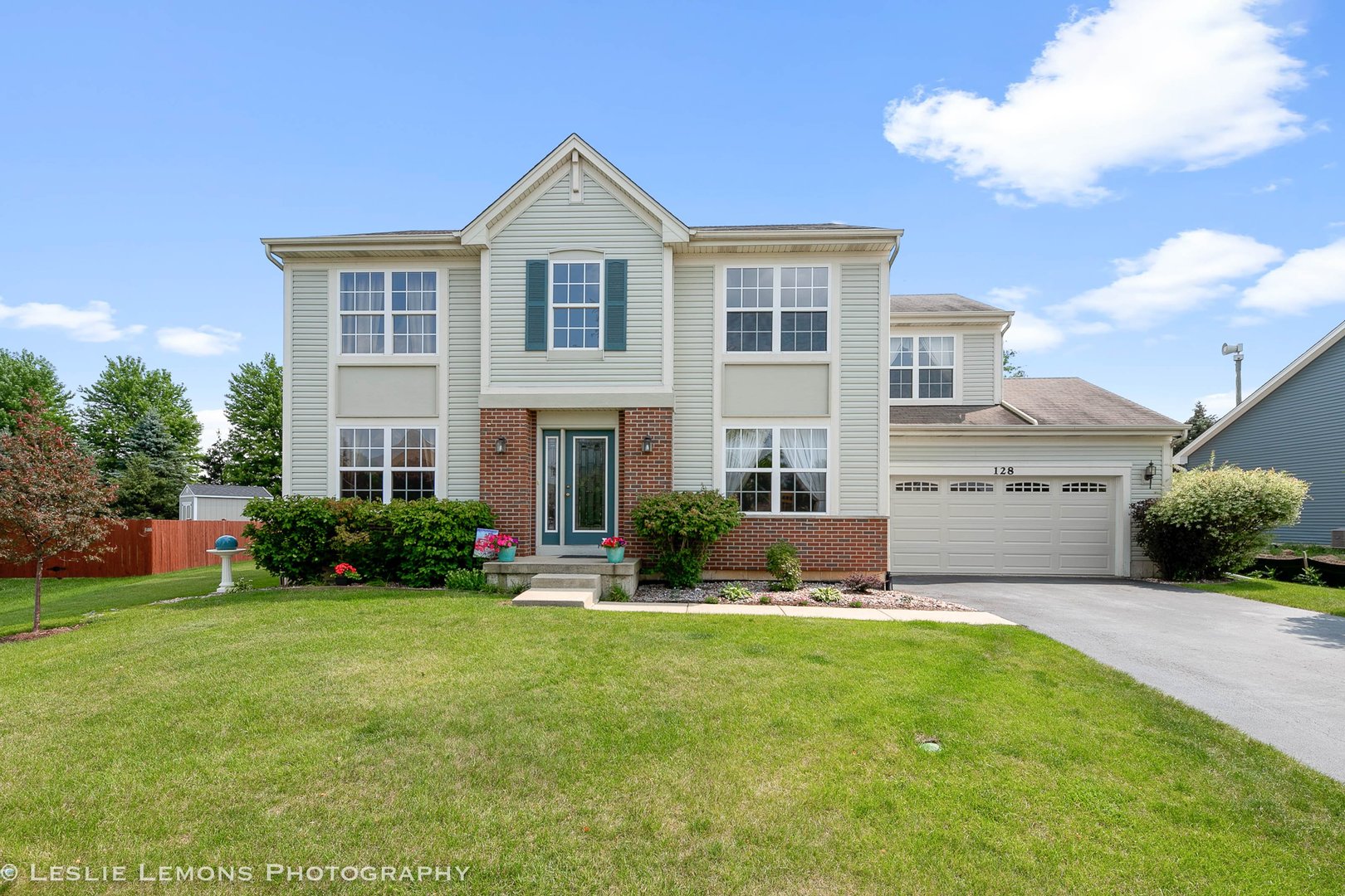 128 Reston Court Sycamore, IL 60178 - Photo 1 of 30 a front view of a house with a yard and garage