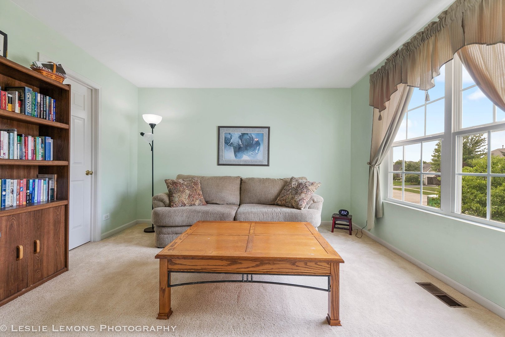 128 Reston Court Sycamore, IL 60178 - Photo 19 of 30 a living room with furniture a rug and a book shelf