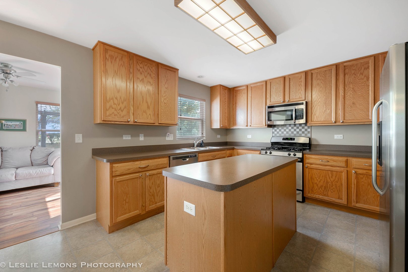 128 Reston Court Sycamore, IL 60178 - Photo 3 of 30 a kitchen with stainless steel appliances granite countertop a sink stove microwave and refrigerator