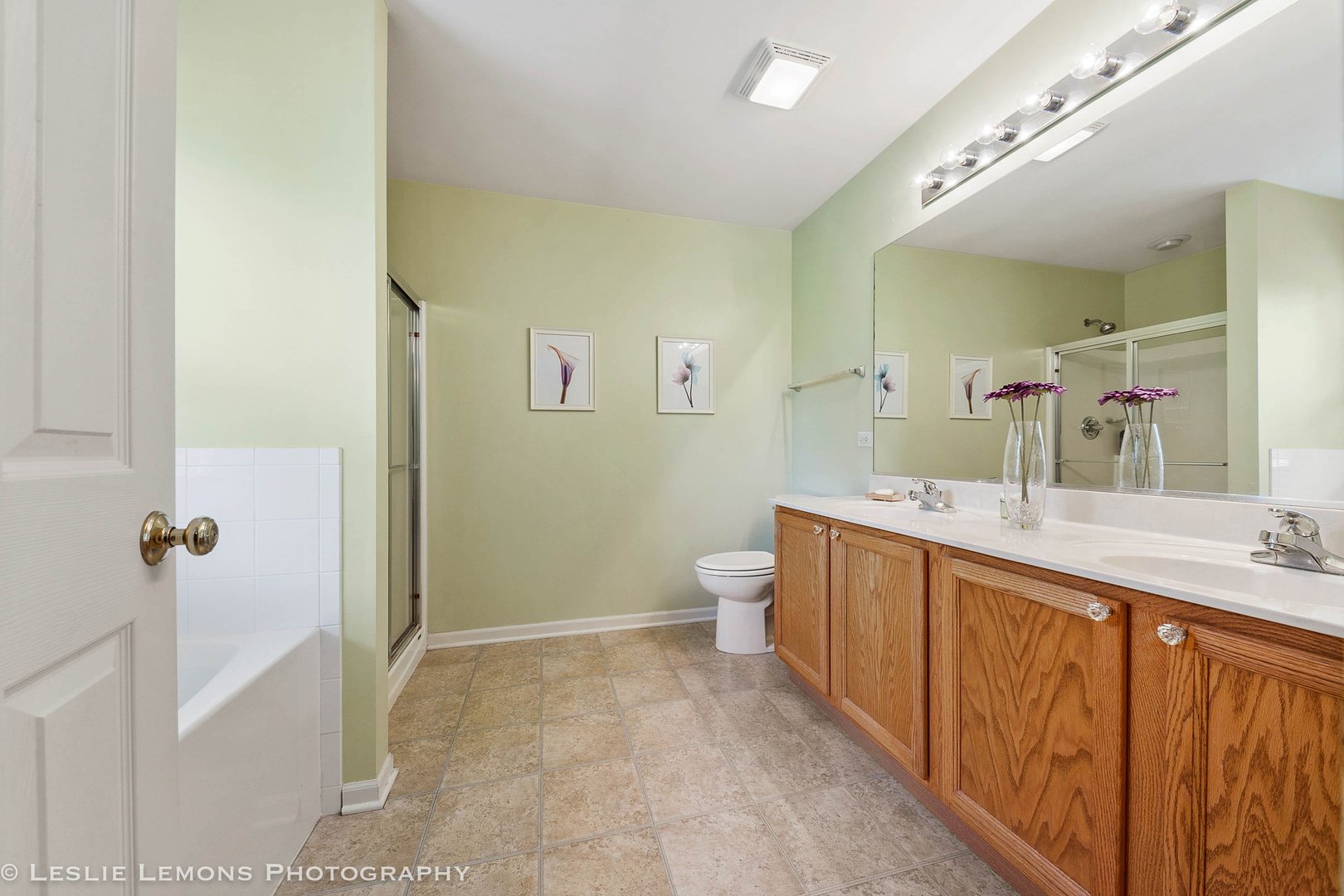 128 Reston Court Sycamore, IL 60178 - Photo 24 of 30 a spacious bathroom with a double vanity sink a mirror and a toilet