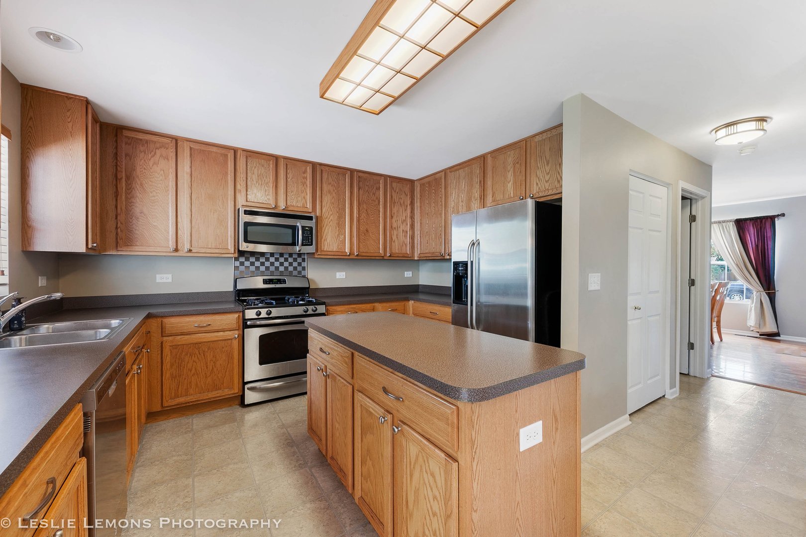 128 Reston Court Sycamore, IL 60178 - Photo 5 of 30 a kitchen with stainless steel appliances granite countertop a refrigerator a stove top oven a sink and dishwasher