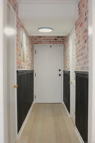 a view of a hallway with wooden shelves