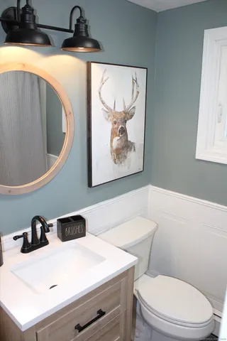 a bathroom with a sink a toilet and a shower