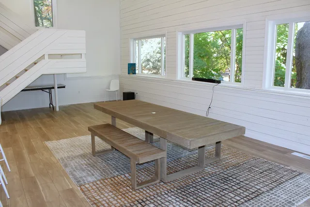 a kitchen with granite countertop chairs and cabinets