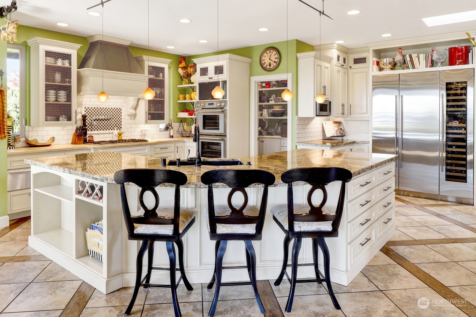 329 Bayside Road Bellingham, WA 98225 - Photo 12 of 40 a kitchen with stainless steel appliances kitchen island granite countertop a table chairs sink and cabinets