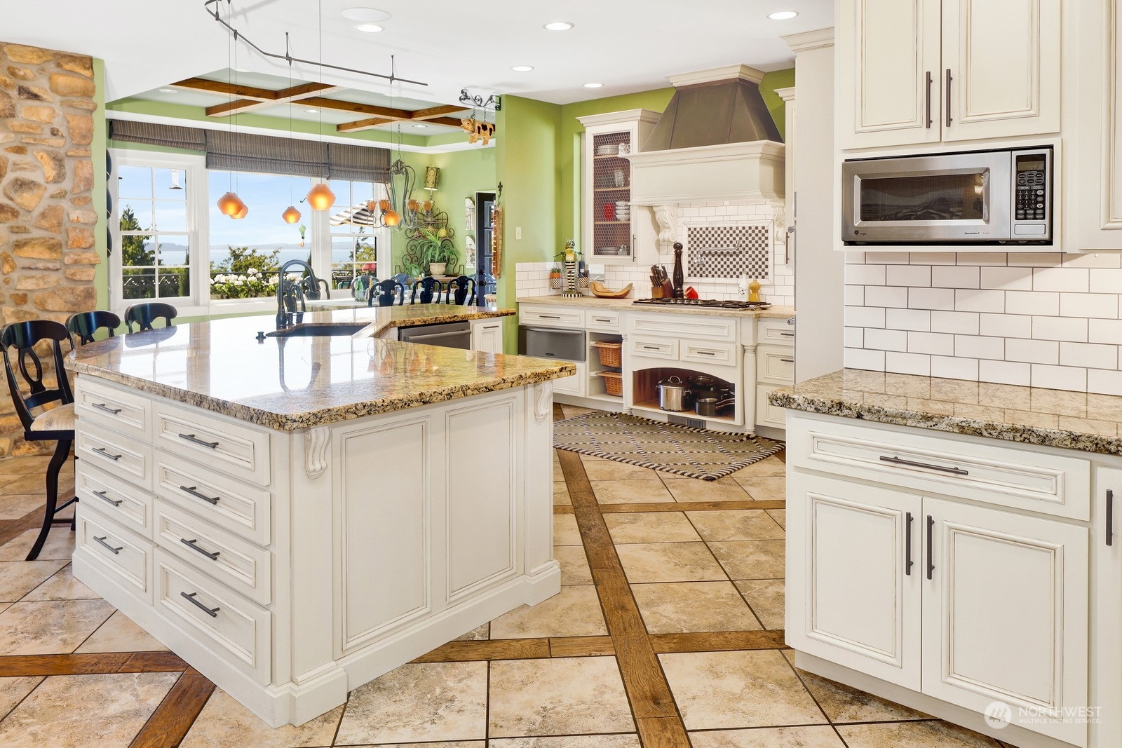 329 Bayside Road Bellingham, WA 98225 - Photo 13 of 40 a kitchen with kitchen island granite countertop a stove a sink and a microwave