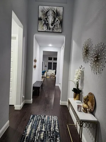 a view of living room with furniture and wooden floor