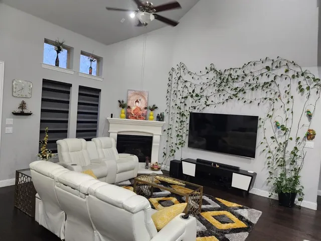a living room with furniture fireplace and a potted plant