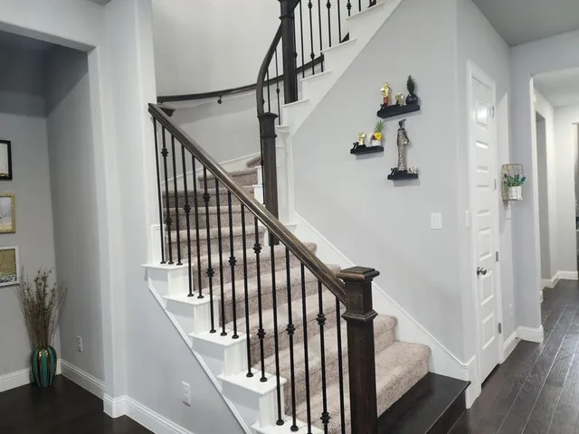 a view of entryway and hall with wooden floor