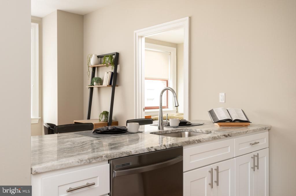 1420-22 Chestnut Street, Unit 705 Philadelphia, PA 19102 - Photo 13 of 35 a kitchen with sink and a mirror