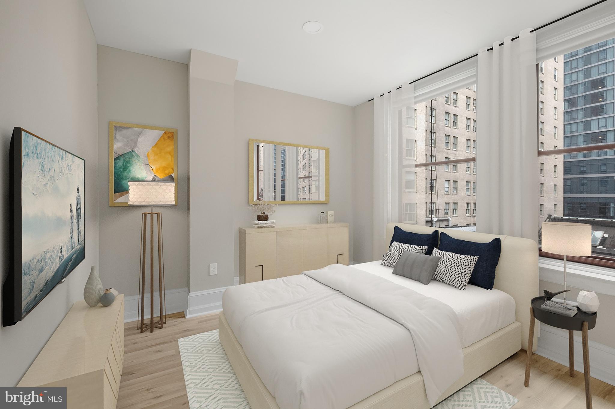 1420-22 Chestnut Street, Unit 705 Philadelphia, PA 19102 - Photo 19 of 35 a bedroom with a large bed and a flat tv screen on dresser