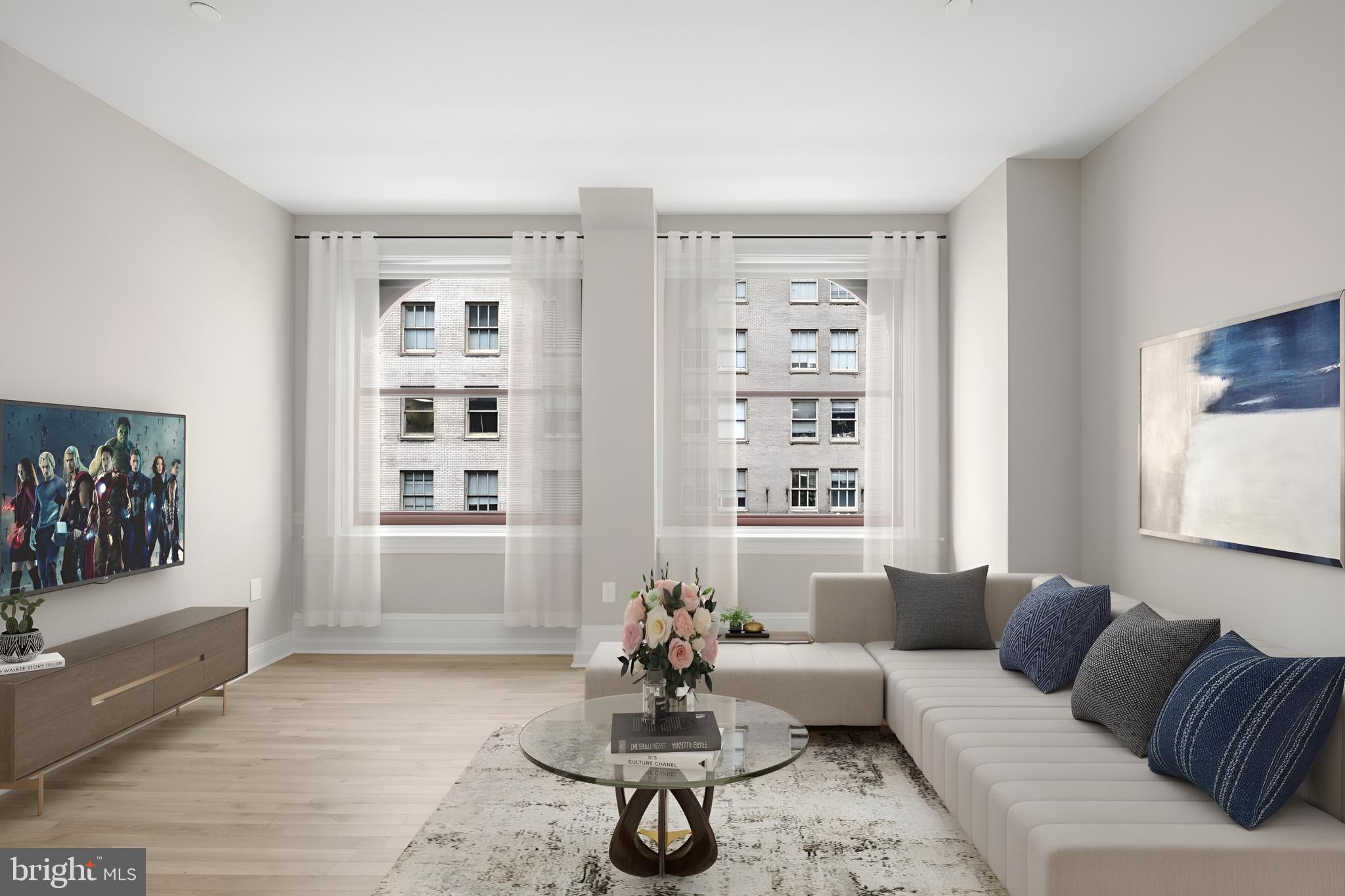 1420-22 Chestnut Street, Unit 705 Philadelphia, PA 19102 - Photo 8 of 35 a living room with furniture and a large window