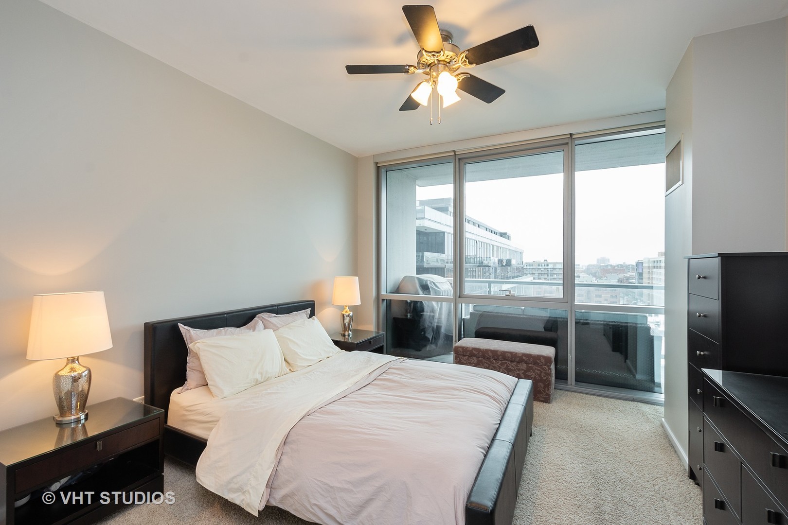 123 South Green Street, Unit 909B Chicago, IL 60607 - Photo 6 of 11 a bedroom with a large bed and a tv