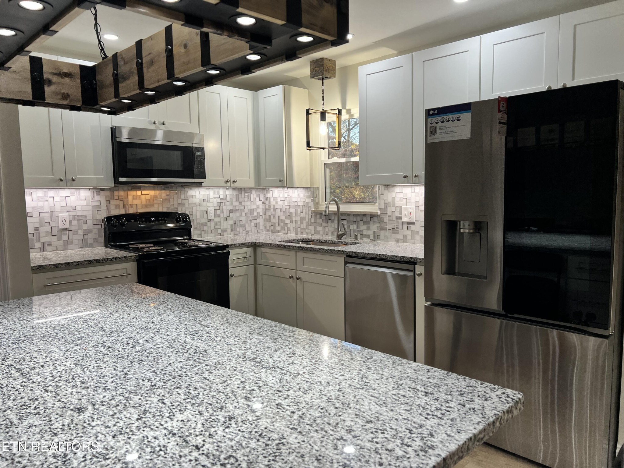 244 Peterson Road Knoxville, TN 37934 - Photo 11 of 46 a kitchen with stainless steel appliances granite countertop a refrigerator a stove and a sink