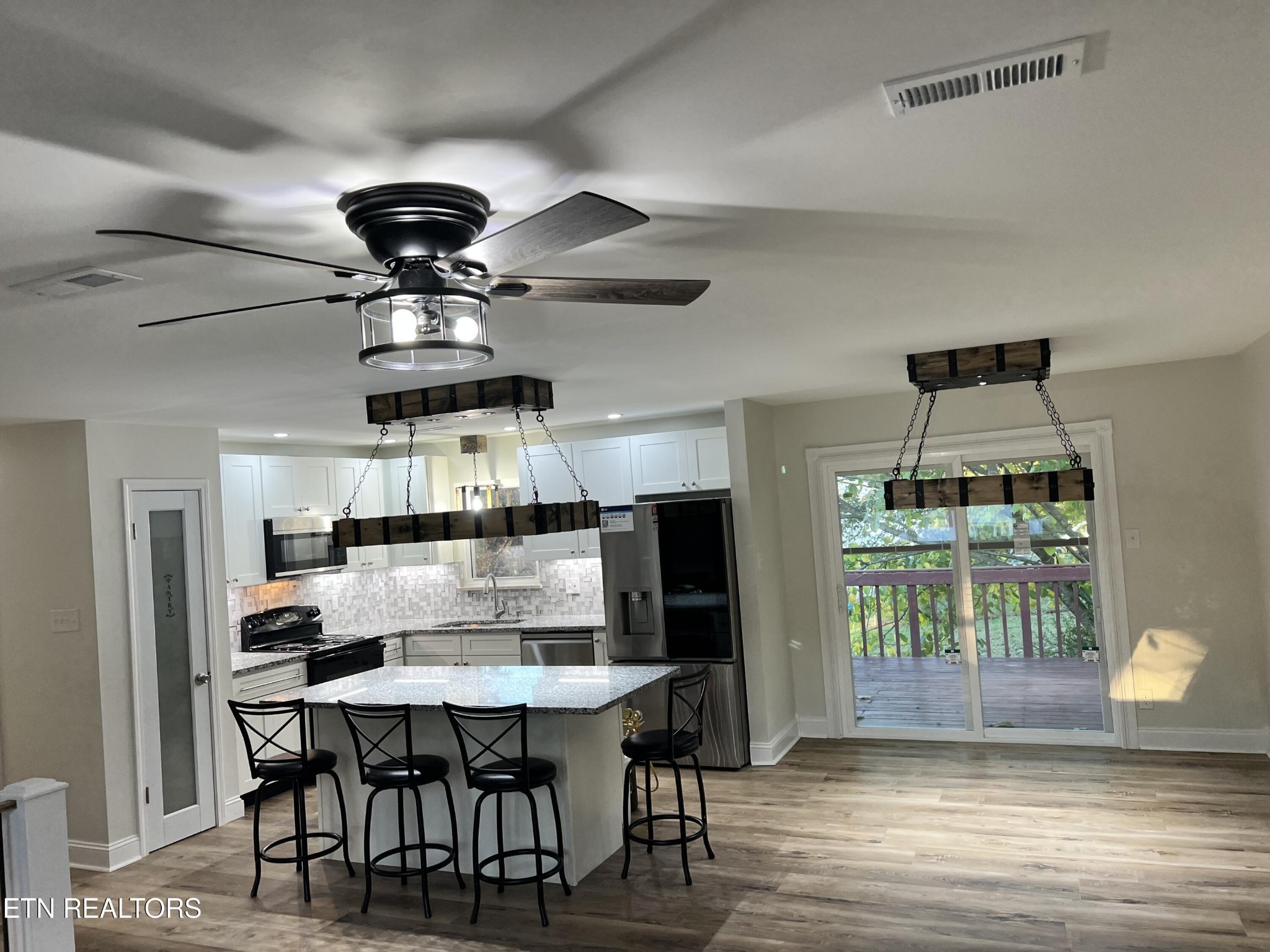 244 Peterson Road Knoxville, TN 37934 - Photo 12 of 46 a kitchen with a dining table chairs and refrigerator