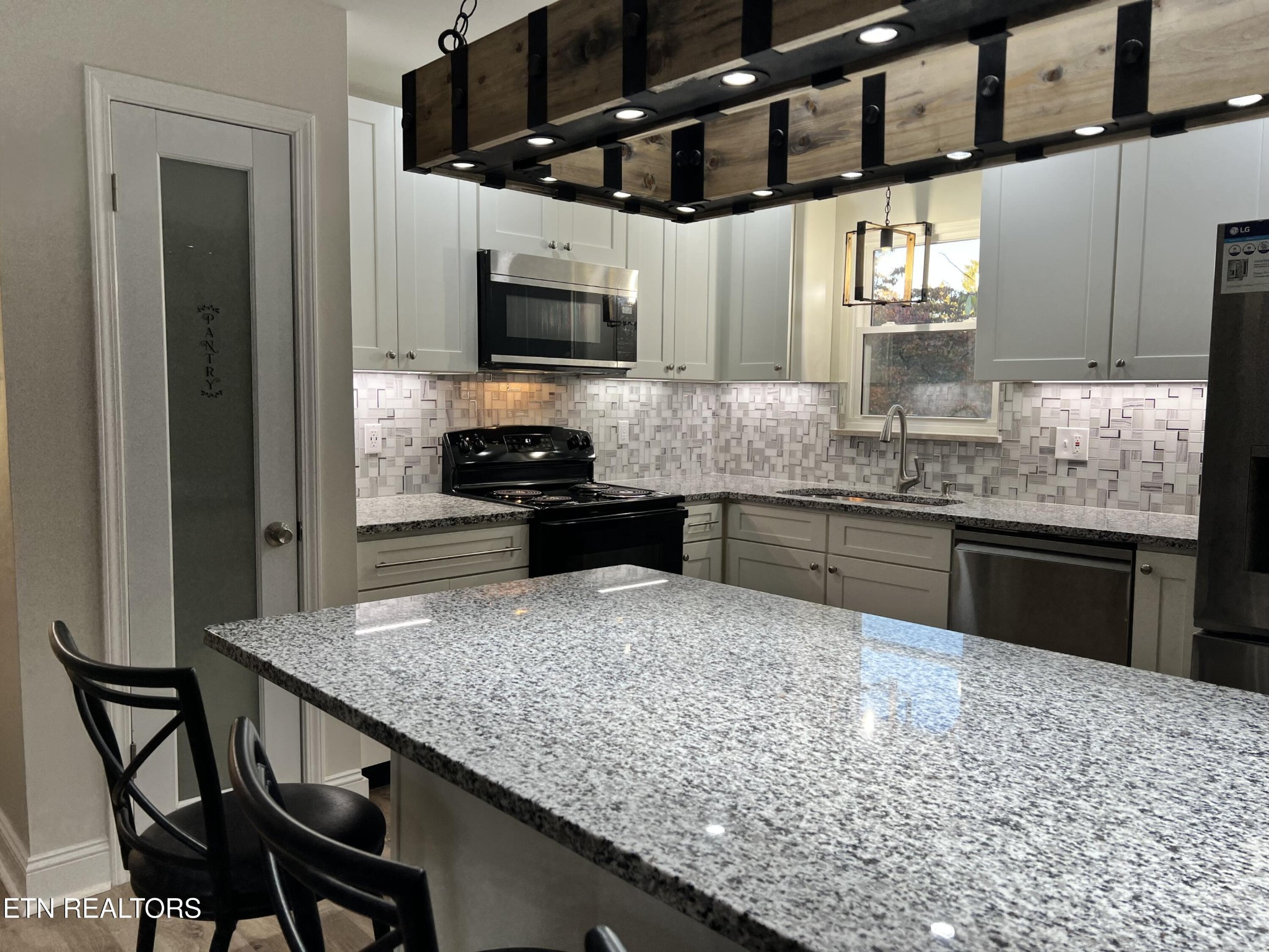 244 Peterson Road Knoxville, TN 37934 - Photo 14 of 46 a kitchen with stainless steel appliances granite countertop a sink and a stove