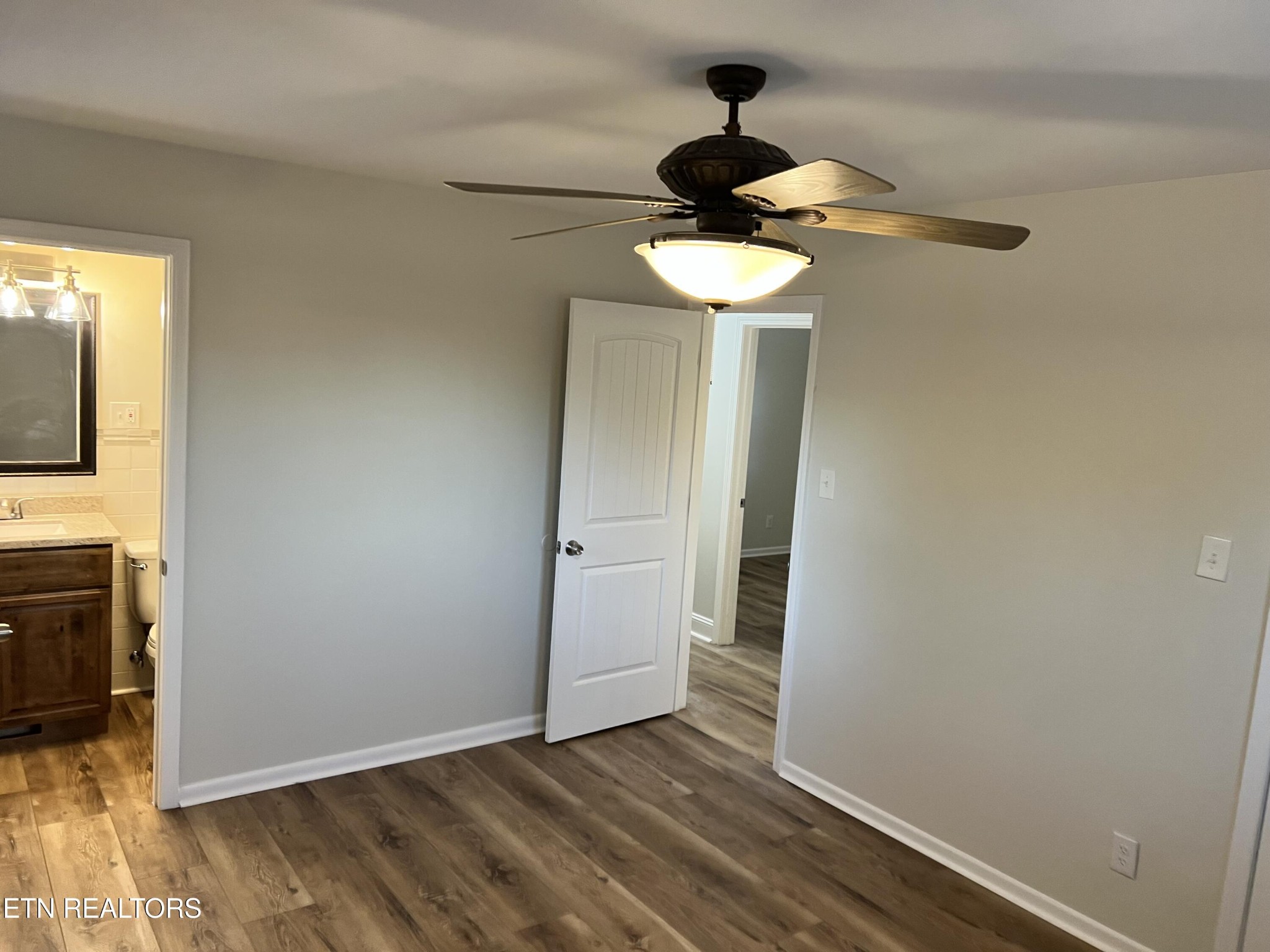 244 Peterson Road Knoxville, TN 37934 - Photo 22 of 46 a view of hallway with a mirror and wooden floor