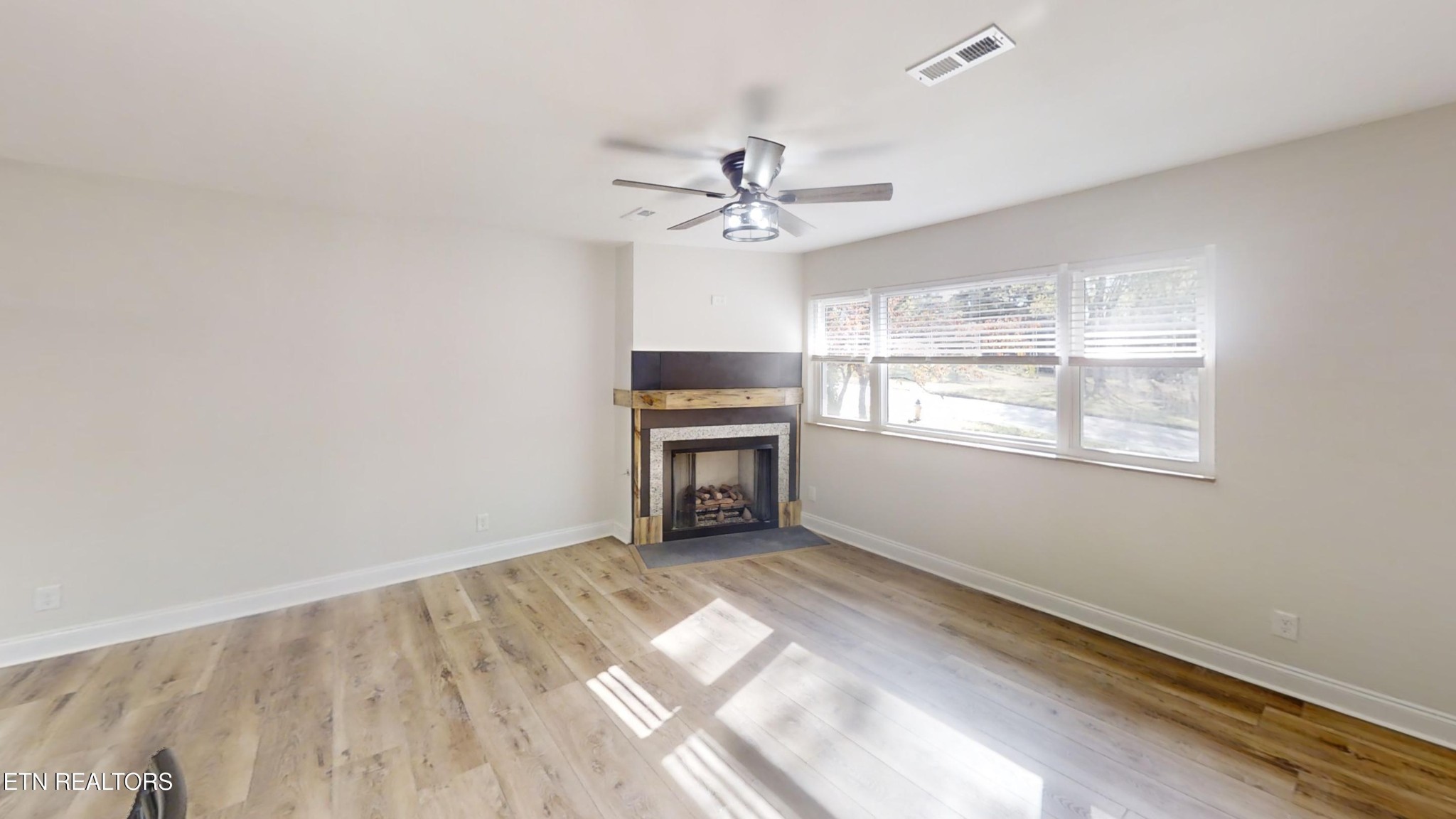 244 Peterson Road Knoxville, TN 37934 - Photo 23 of 46 an empty room with windows and ceiling fan