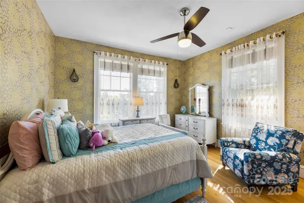 a bedroom with a bed couch and window