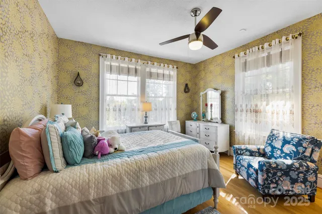 a bedroom with a bed couch and window