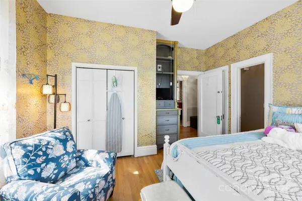 a bedroom with a bed and wooden floor