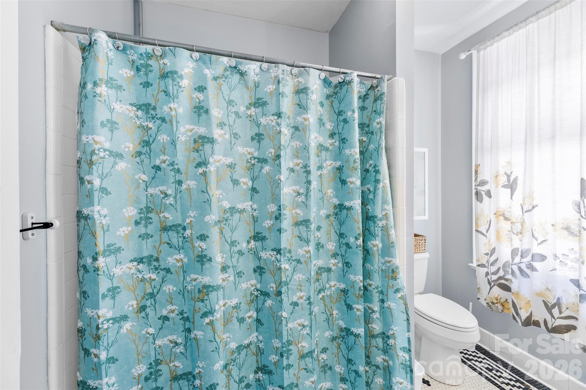 705 West Main Street Albemarle, NC 28001 - Photo 20 of 39 a white toilet sitting next to a shower curtain