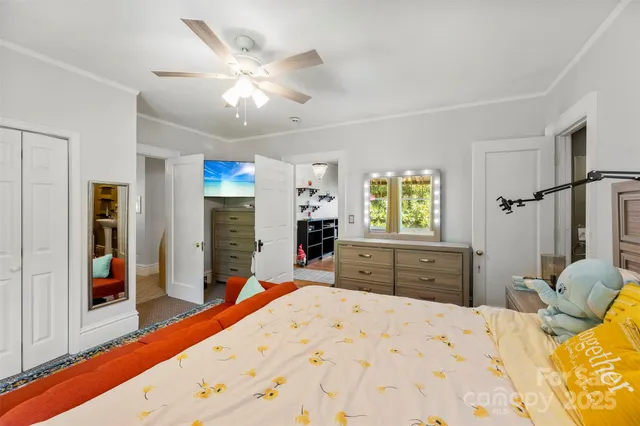 a bed room with a bed and a flat tv screen on dresser